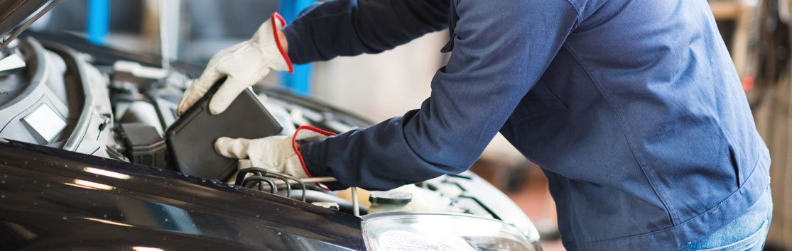 Repair Man Working on Engine